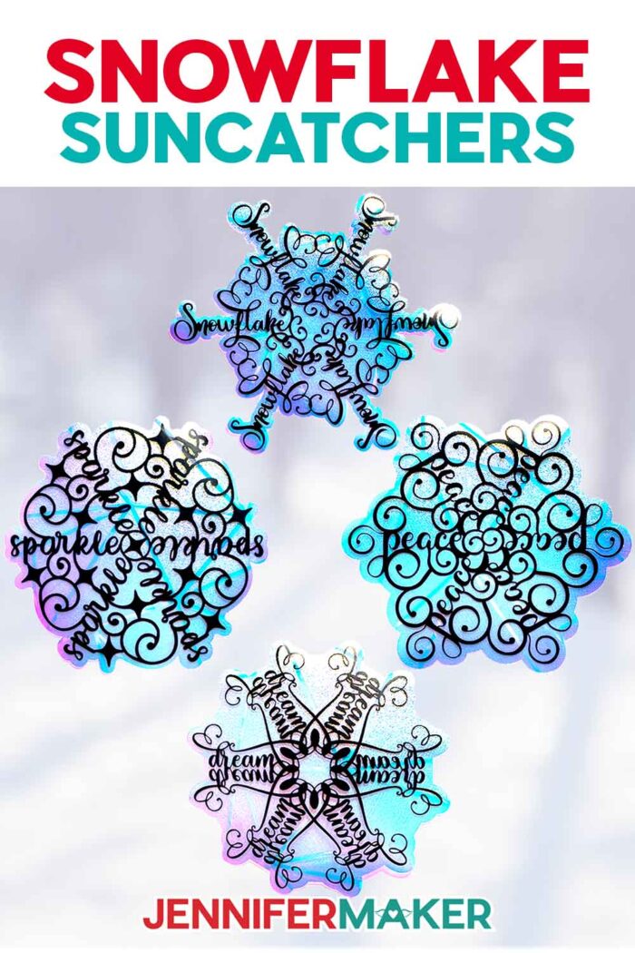 A window from inside the studio at Maker Farm look out onto a snowy landscape -- the windows are decorated with four snowflake-shaped window clings with free stylized word art designs from the free Festive Snowflake Designs tutorial by JenniferMaker