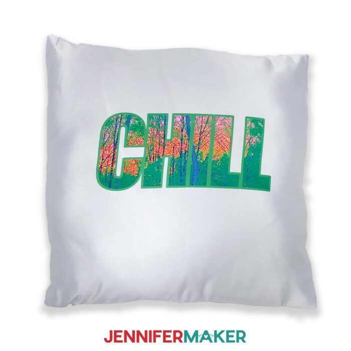 White pillow with a bold font design reading CHILL with a sunset photo filling the letters.