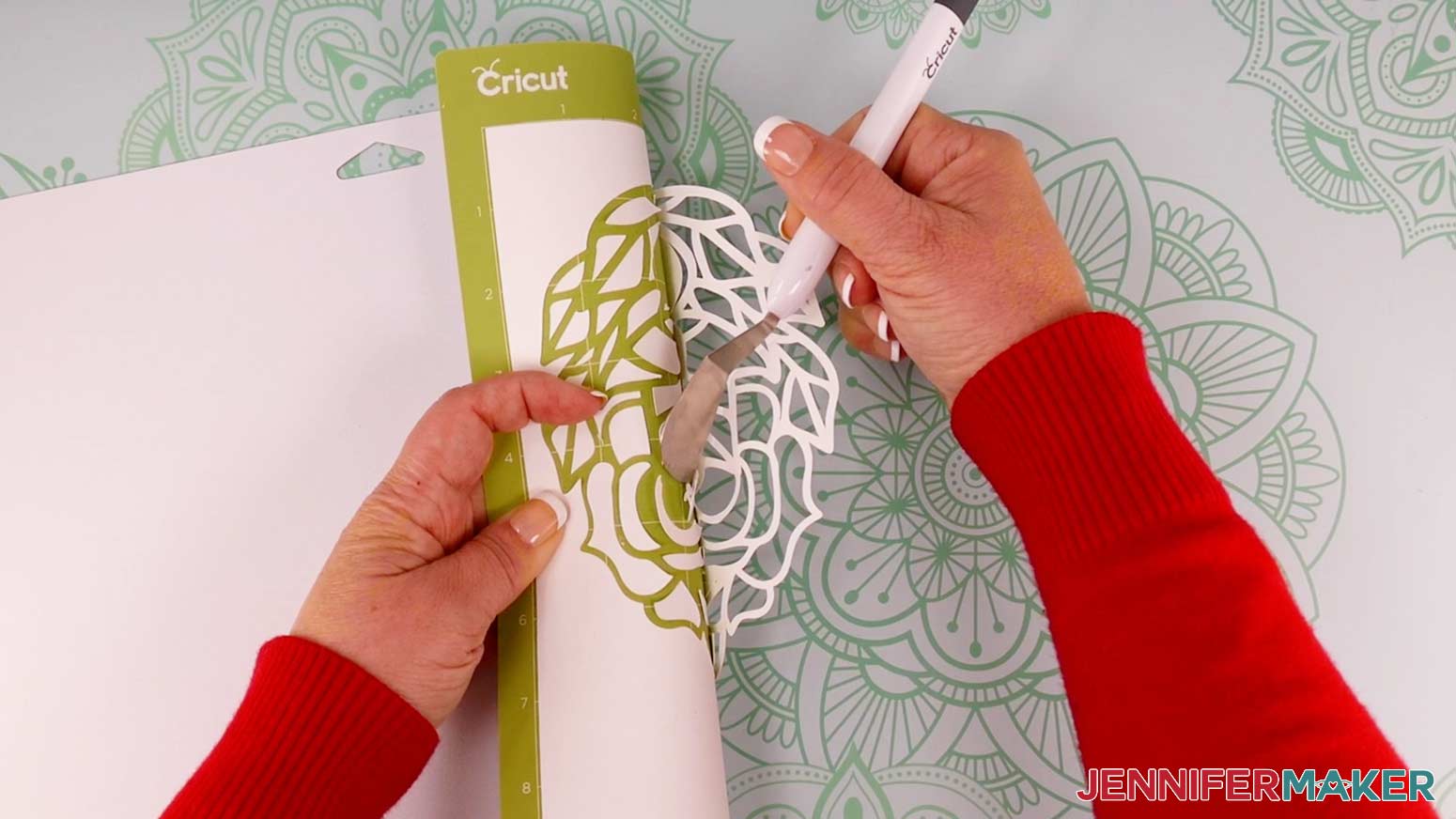 Use a spatula to carefully remove the intricate cut pieces from the cutting mat.