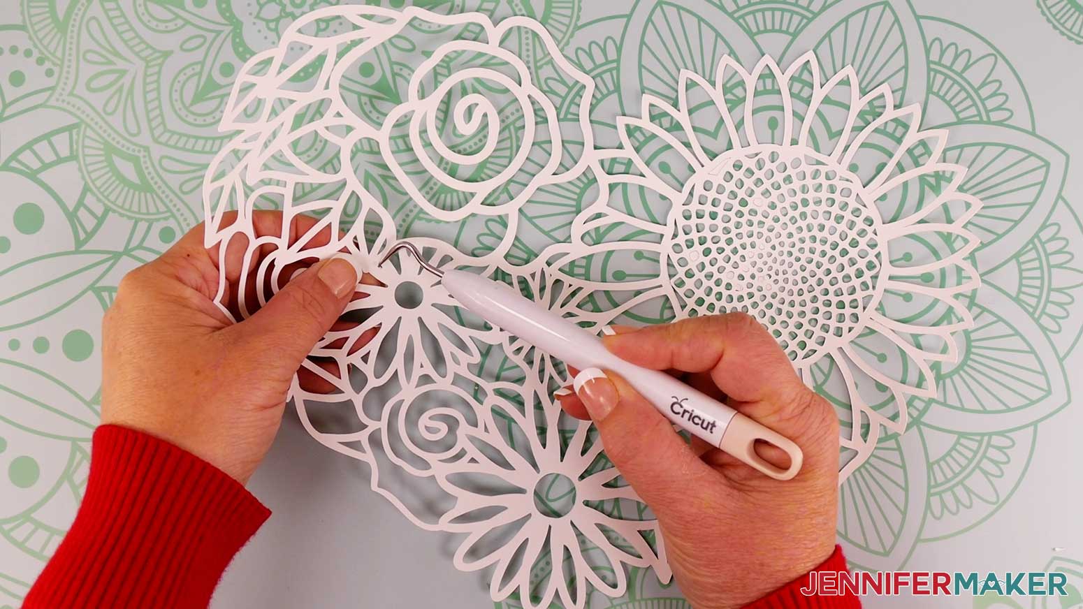 Use a weeding tool to remove small pieces of cardstock that did not stay behind when removing the cut floral heart from the mat.