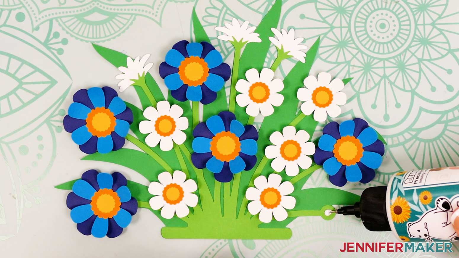 Adhere the 12 assembled flowers on top of the foliage piece circles.