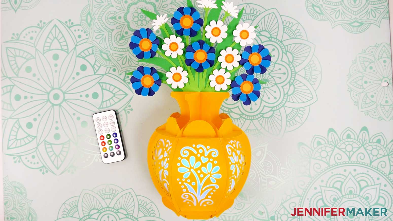 A finished flower bouquet lantern with a yellow vase and blue and white flowers.