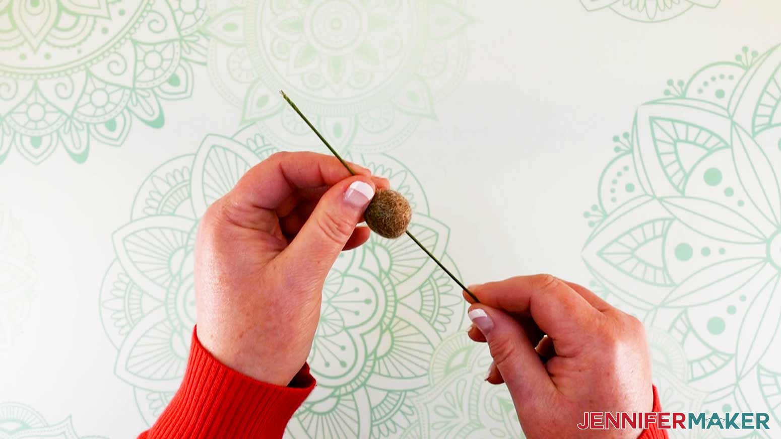 Feeding wire through wool ball head of flower fairy doll