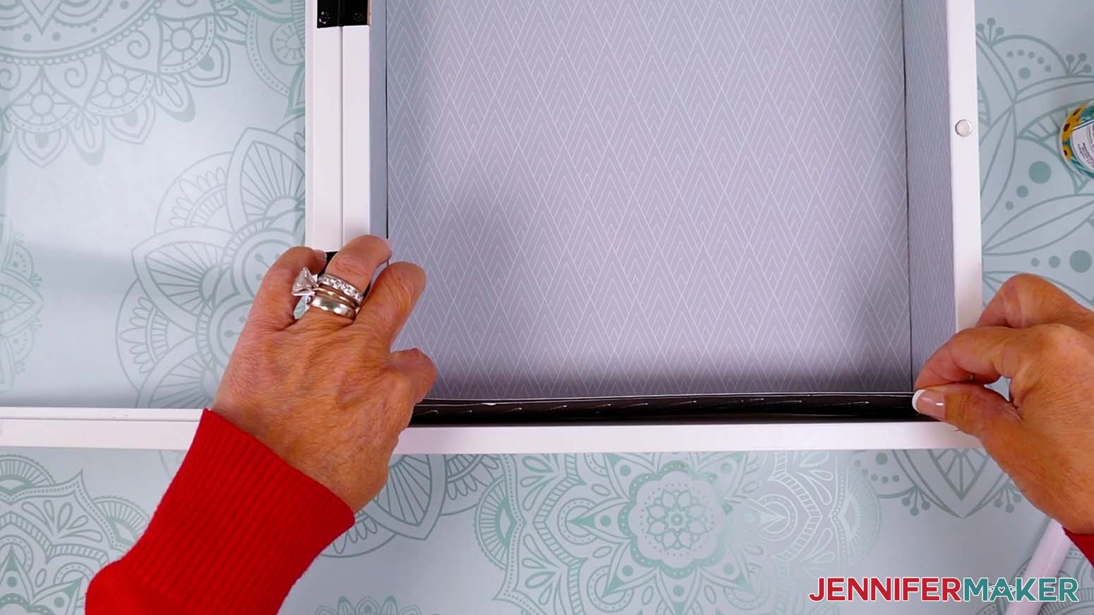Adhere the floor piece of cardstock to the inside bottom of the shadow box.
