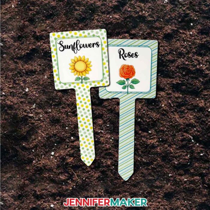 A pair of sublimated plant stakes, each with a photo of a flower and its name labeled across the top: "Sunflowers," and "Roses."