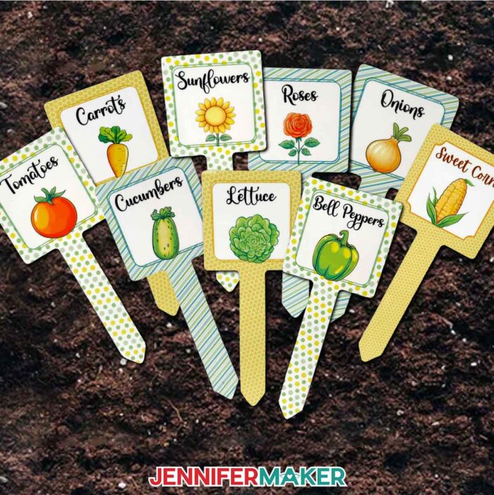 A full set of sublimated plant stakes resting in soil. This tutorial shows you how to fix common sublimation issues so you can make this set of plant stakes, too!