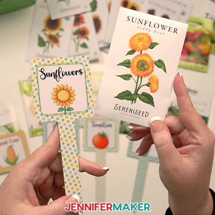 Jennifer holds up a sublimated "Sunflowers" plant stake and matching sunflower seed packet.