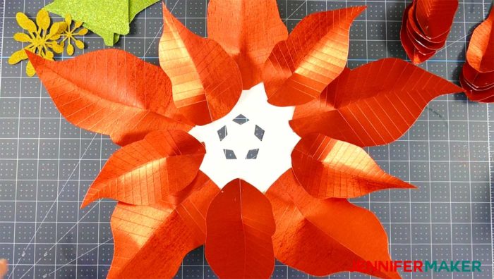 Arranging the leaves on the giant paper poinsettia flower