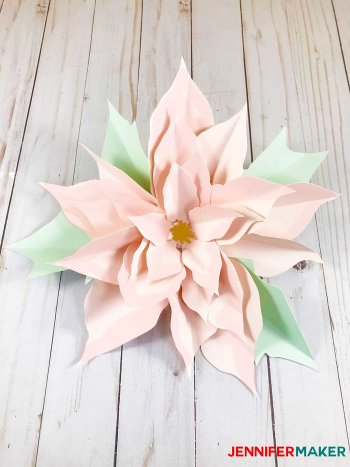 A pastel pink paper poinsettia flower