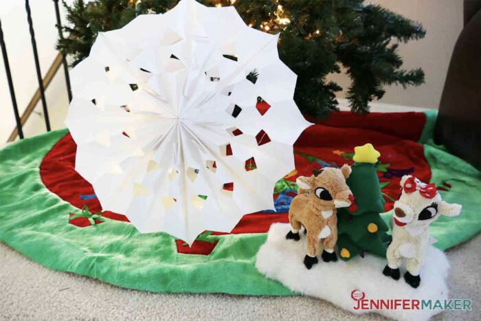 Giant paper snowflake under a Christmas Tree