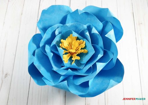 The finished blue giant paper winter rose with a yellow stamen