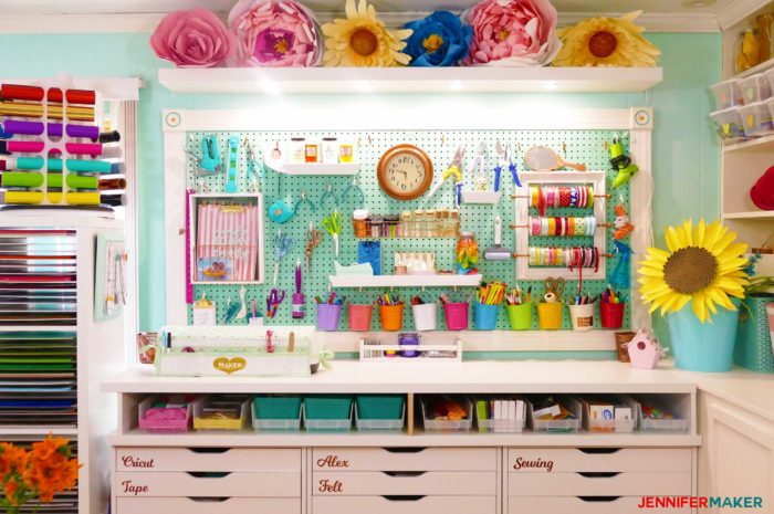 My large framed pegboard filled with craft tools, accessories, buckets, shelves, and my ribbon storage!