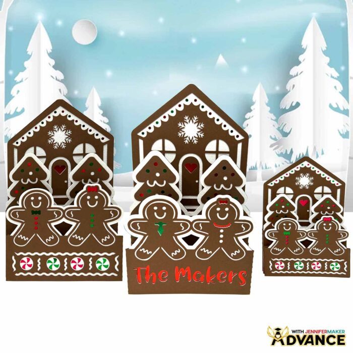 Three brown Gingerbread House Pop-Up Card designs on display, each with slightly different details and little "cookie" people. One is a design taught in the ADVANCE by JenniferMaker program