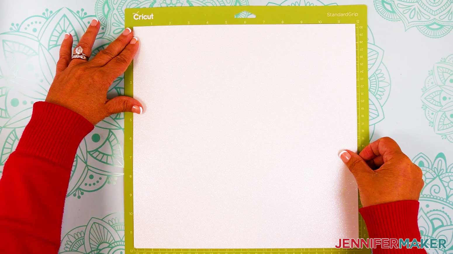 Place the white glitter cardstock face up on a green machine mat.