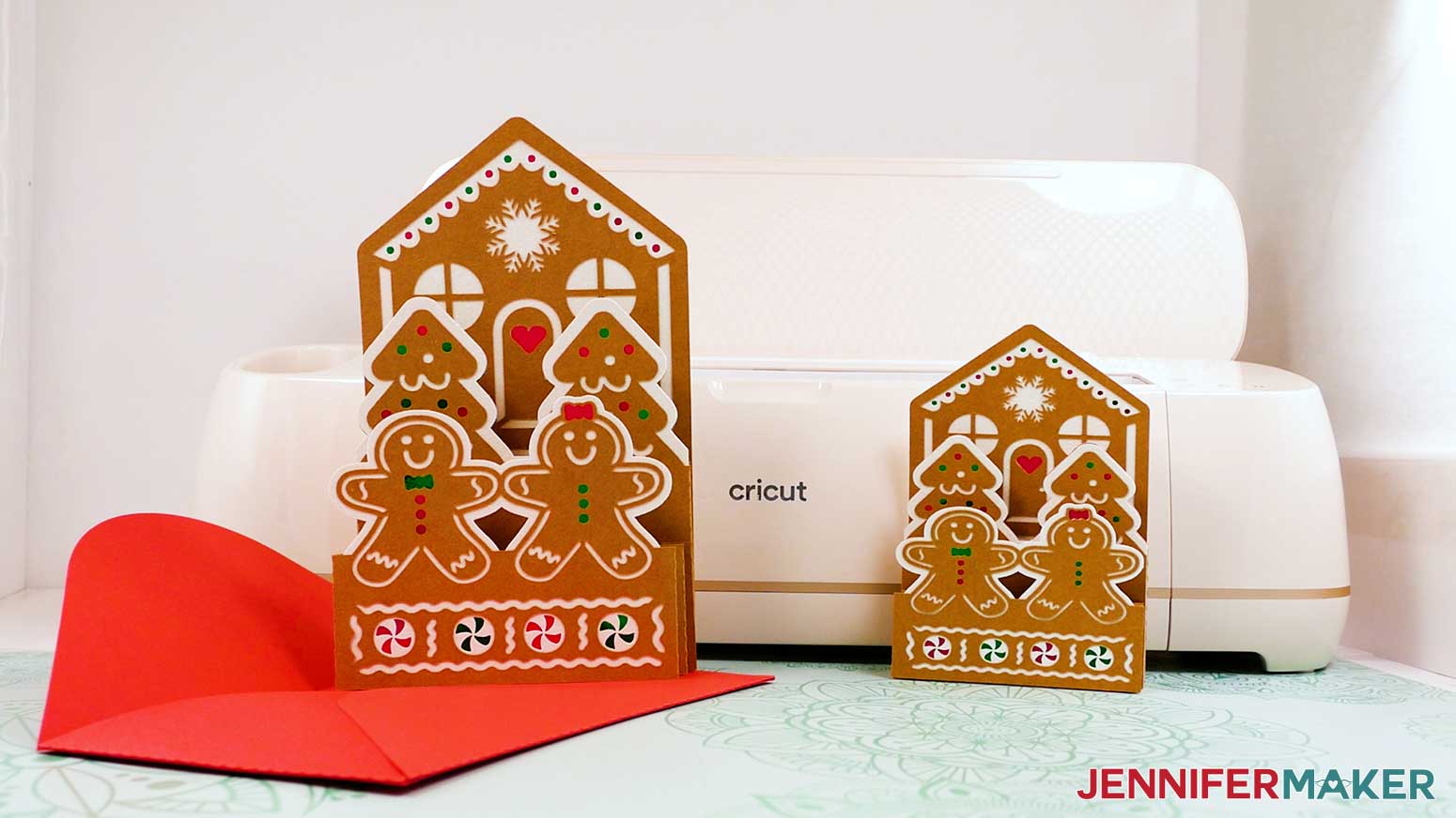 Finished joy and large size gingerbread house card with envelope in front of Cricut.