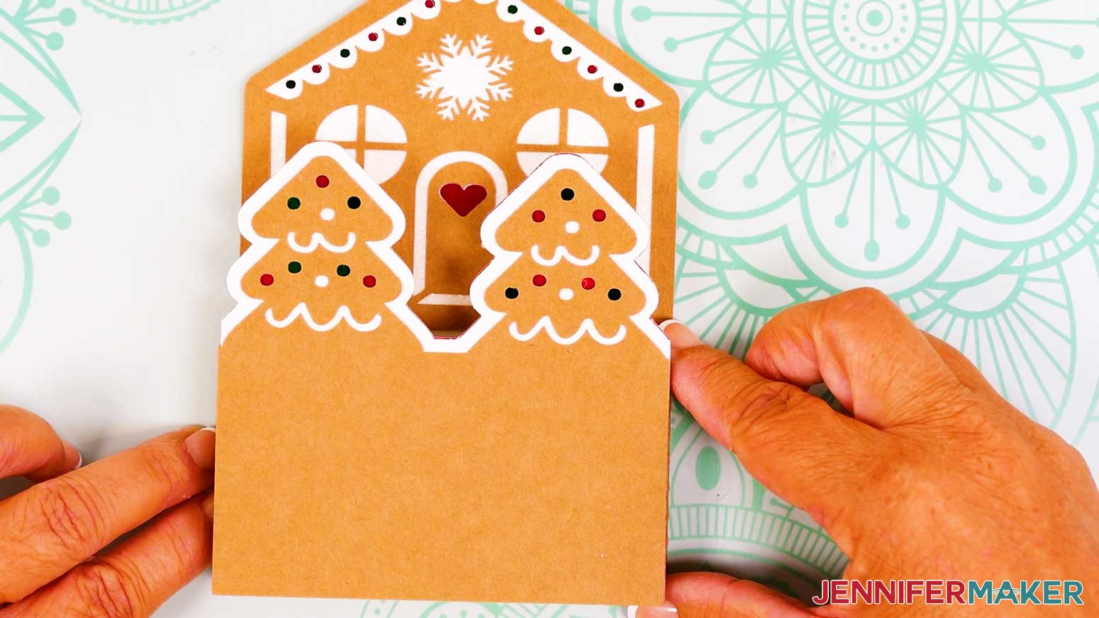 House tier of the joy size gingerbread pop-up card is face up and the tree tier is adhered to it.