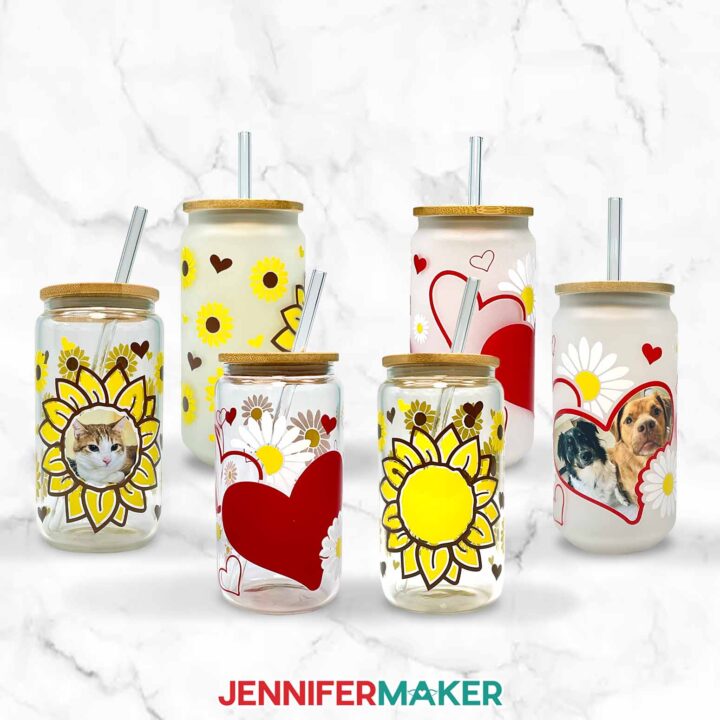 Learn to make vinyl glass can wraps with Jennifer Maker's tutorial! Six glass cans are decorated with heart and flower designs.