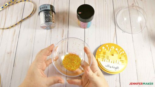 Fill up one half of the clear ornament with gold glitter