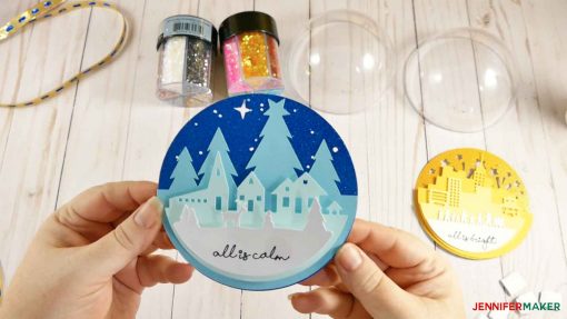 Attach the final layer of your scene for your glitter ball ornament