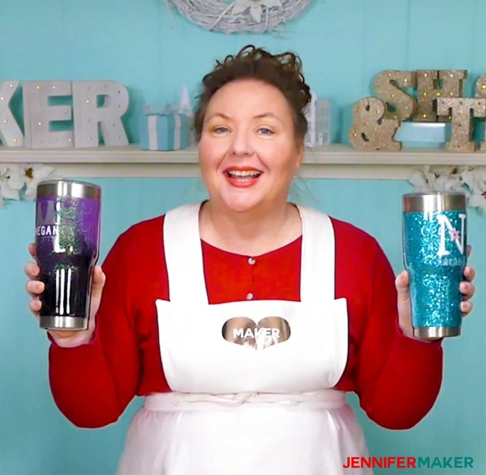 Jennifer holding two glitter tumblers in her craft room