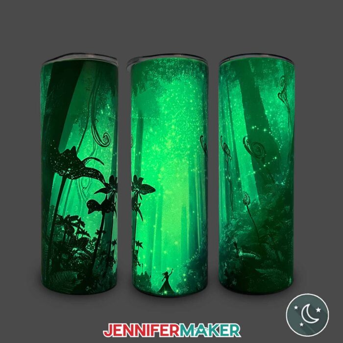 Three views of a Glow In The Dark Tumbler With Reverse Sublimation design of a woman in a mystical, enchanted forest
