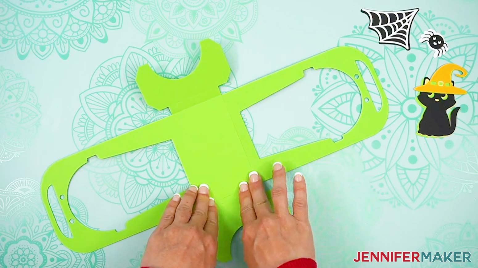 Form a rectangle with the bottoms of the two Halloween treat cup holder base pieces overlapping each other.
