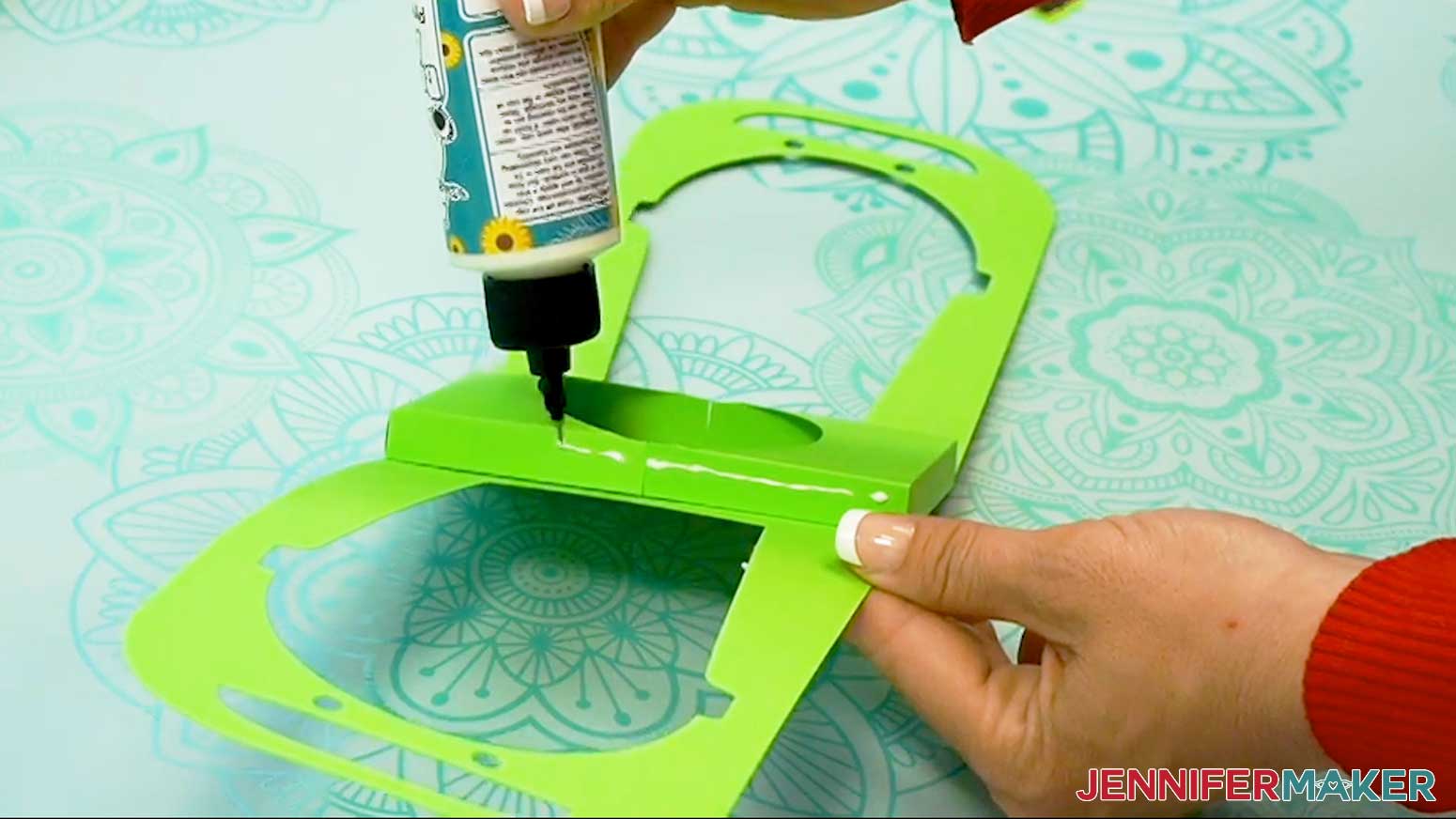 Add glue to the sides of the Halloween treat cup holder cup pocket pieces to hold the base assembly closed at the pocket area.