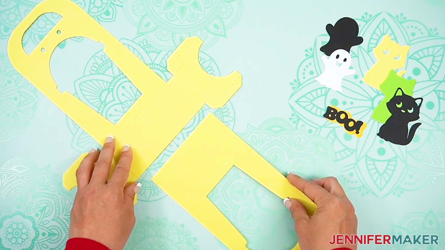 Line the base pieces of the Halloween treat cup holder assembly up to make a rectangle in the center.