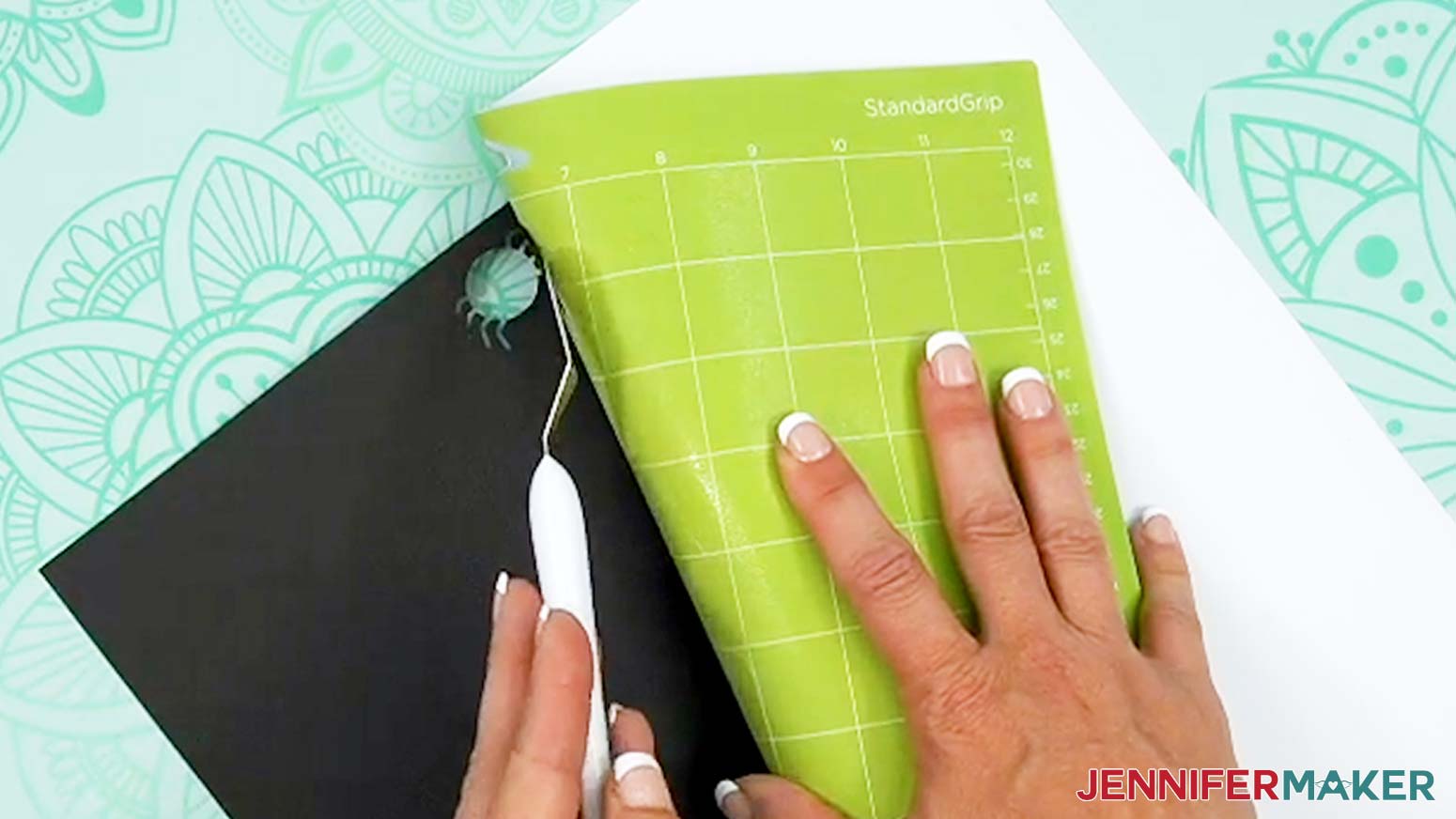 Use a spatula to remove delicate cut pieces of the Halloween treat cup holder from the machine mat.