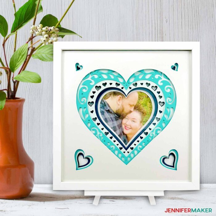 Layered Heart of white and blue cardstock with a photo of a couple in a frame 
