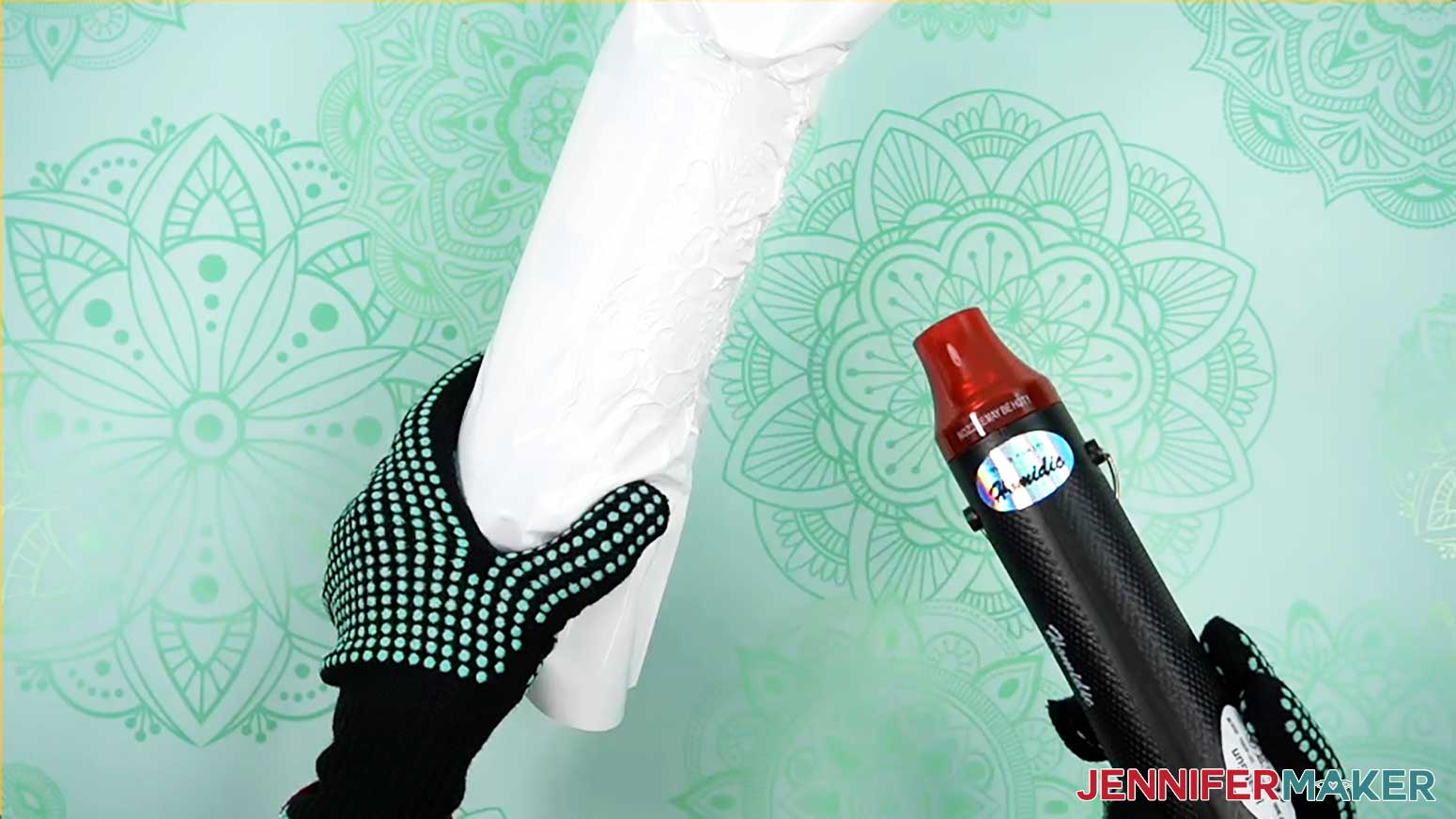 Heat resistant gloves hold tumbler while using heat gun on shrink wrap
