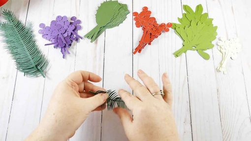 Fold your paper leaves and branches for your holiday kissing ball