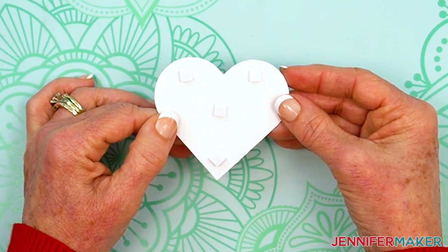 Place several small foam adhesive squares on the back of the heart element.