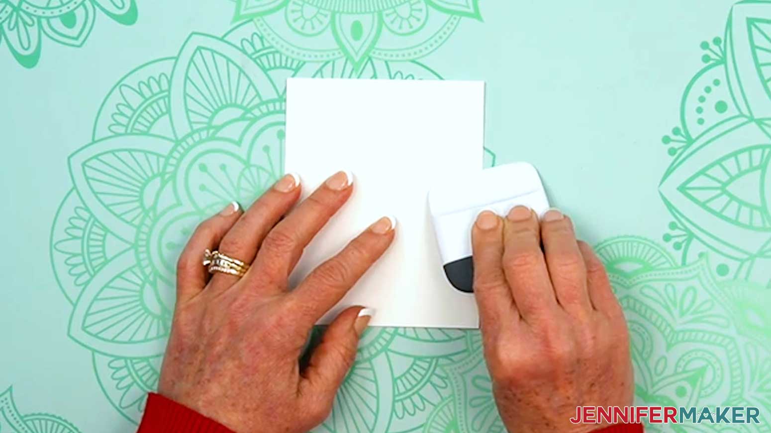 Use a scraper tool to make a crisp fold along the score line.