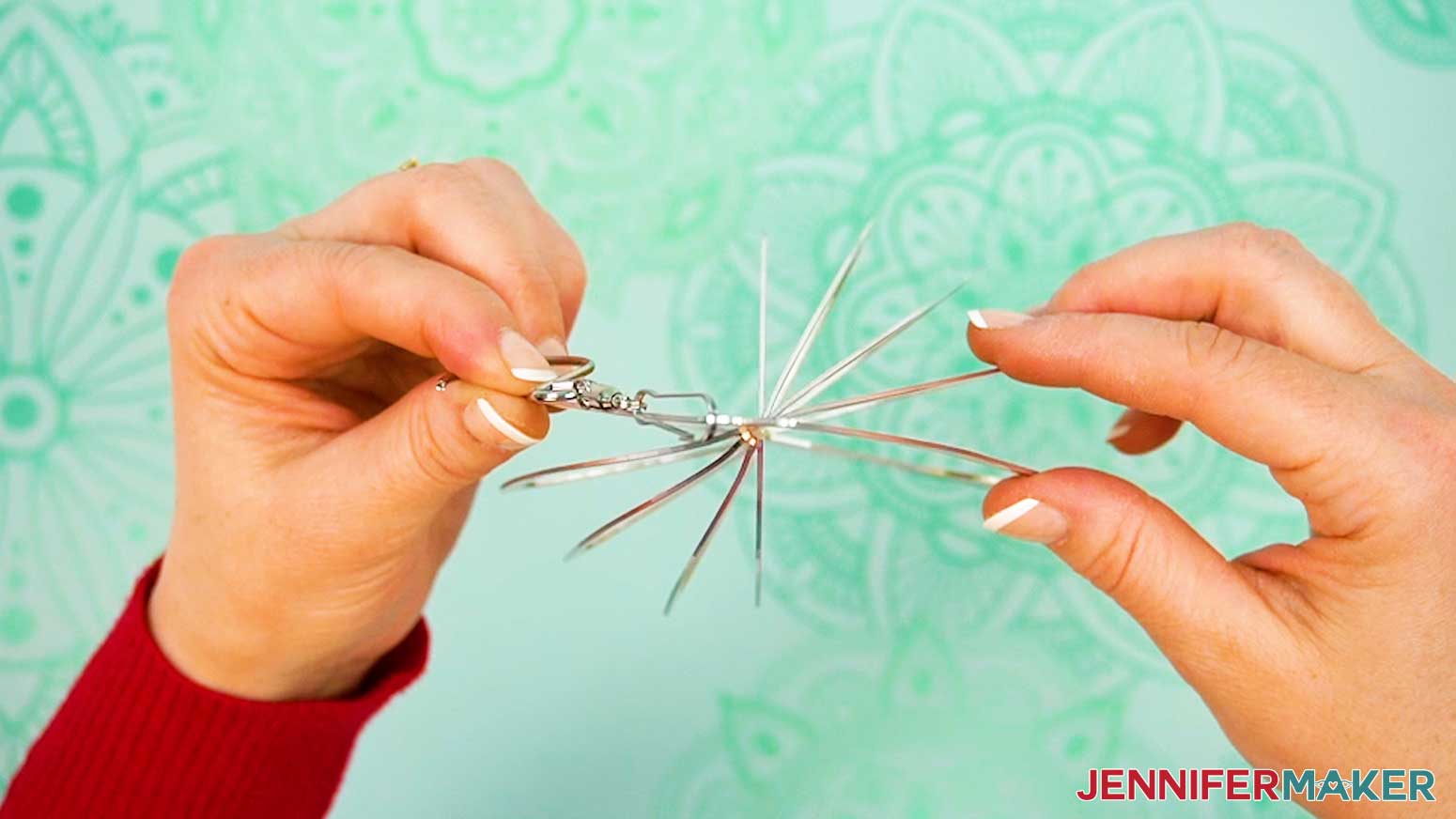 Continue spacing out the rings of the shaped wind spinner.