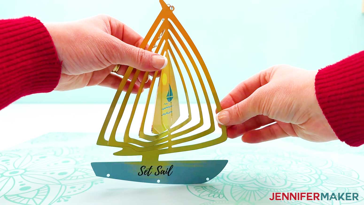 Bend the center piece of the shaped wind spinner out.