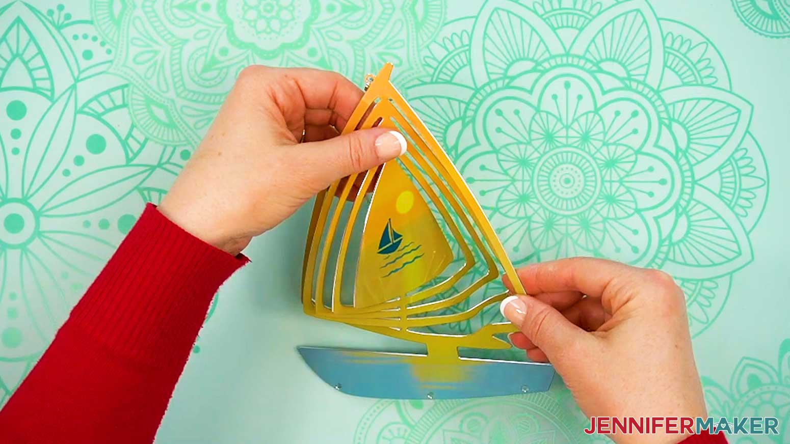 Carefully bend out each layer of the rings inside the shaped wind spinner main piece.