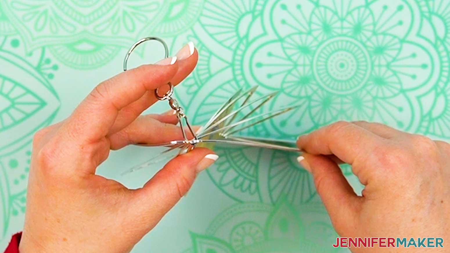Carefully press open the second ring of the shaped wind spinner main piece.