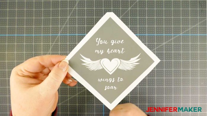 A vinyl decal with a winged heart for etching a glass coaster