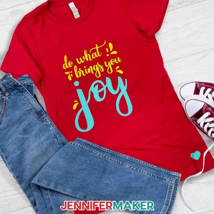 A red t-shirt with a duo-tone design created using the JenniferMaker how to iron on Cricut vinyl tutorial.