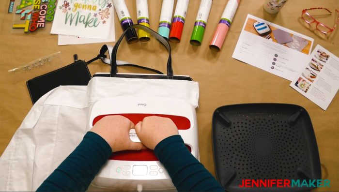 Pressing the Cricut EasyPress on the layered iron on design on a tote bag