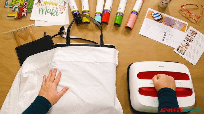 A white pillowcase over a black tote bag to protect the surface when making layered iron on vinyl designs