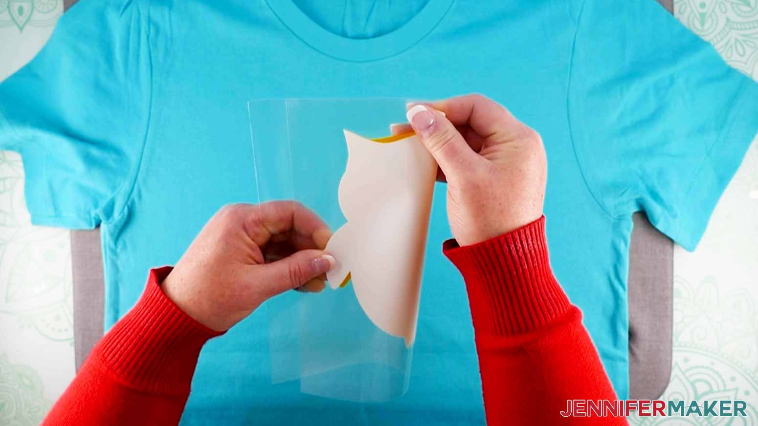 Folding vinyl layer in half (sticky side OUT) for how to layer vinyl on a shirt