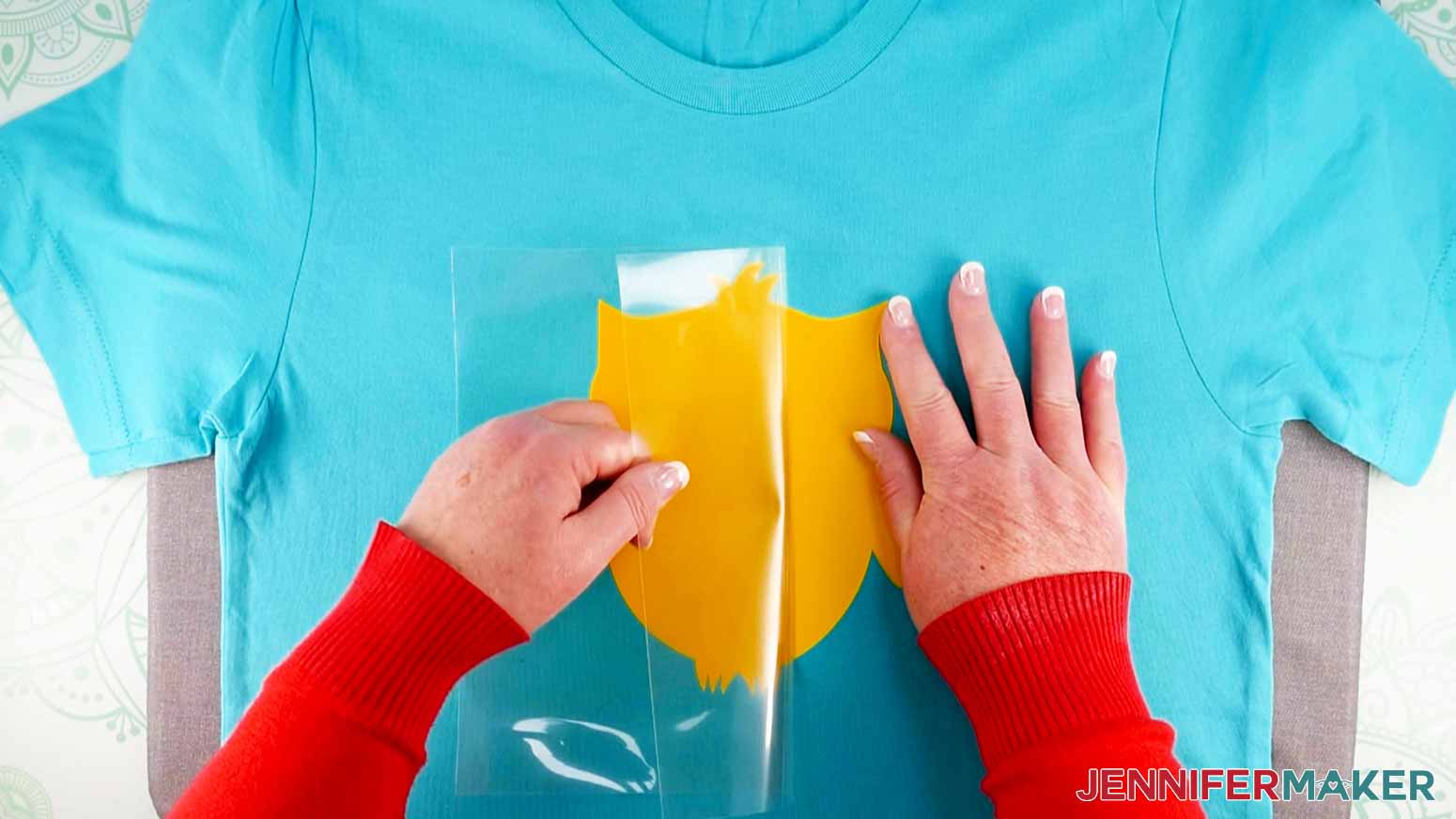 Peeling off carrier sheet from first layer for how to layer vinyl on a shirt