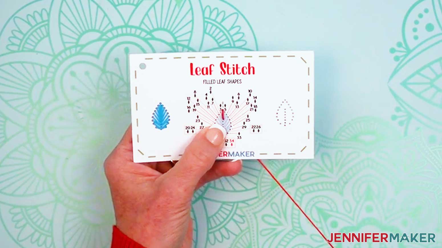 Push the needle down through hole two to make the center vertical line for the Embroidery Stitch Book Leaf Stitch.