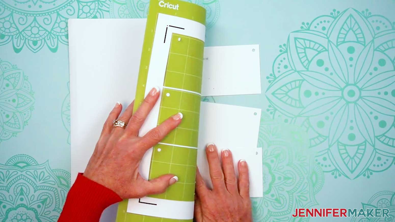 Remove the cut Embroidery Stitch Book pages from the machine mat.