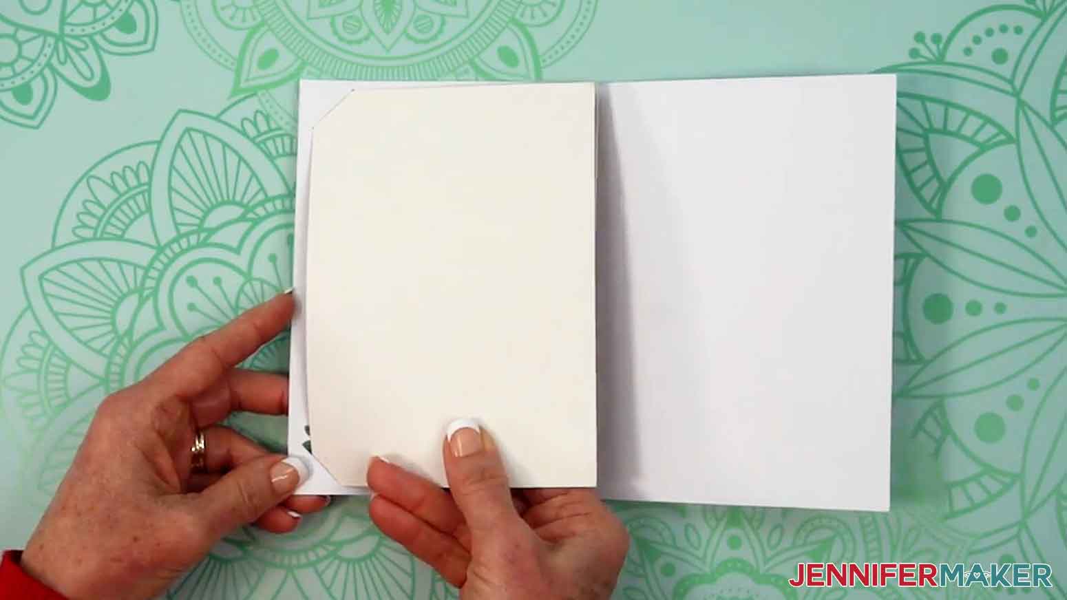 The insert card is being put into the outer cut and drawn lover card at the corners.