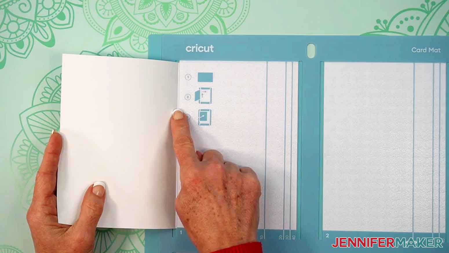 The card is being aligned using a finger to hold it in place at the fold.