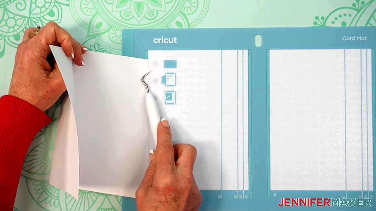 A scraper is used to lift up the card mat while the card is being slide into the proper slot on the card mat.