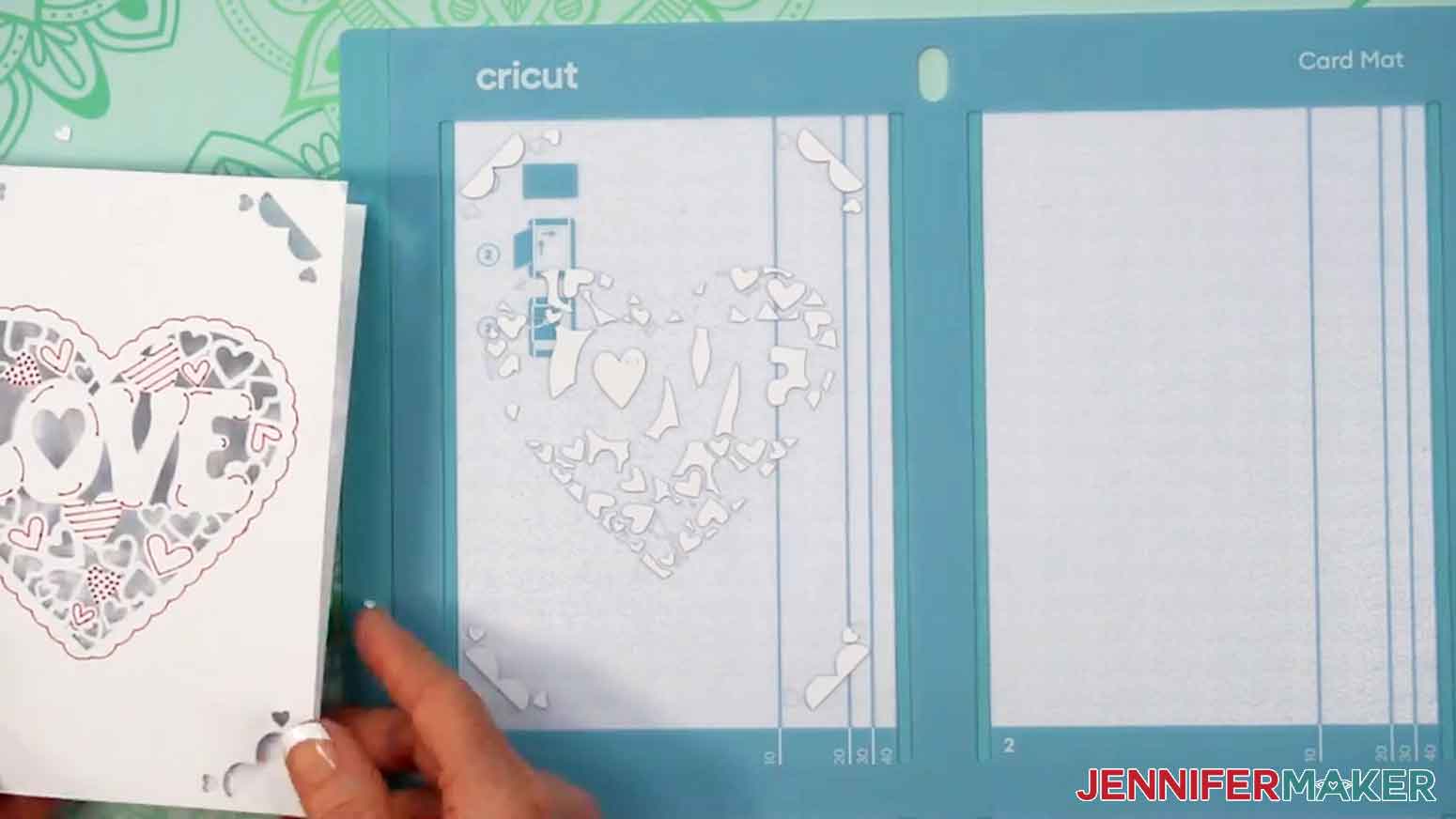The card has been removed and the cut out pieces are shown left behind on the mat.